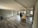 Open living room and kitchen with gray walls and vinyl flooring at 2289 Aurie Dr, Decatur, GA 30034
