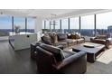 Spacious living room with floor to ceiling windows, leather sofas, and city views at 3630 Peachtree Ne Rd # 2104, Atlanta, GA 30326