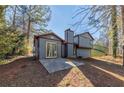 Rear view of a house showing a patio and surrounding trees at 5370 Biffle Ln, Stone Mountain, GA 30088