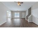 Bright living room with hardwood floors, a ceiling fan, and stairs at 5370 Biffle Ln, Stone Mountain, GA 30088