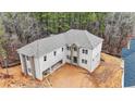 Aerial view of a large two-story home with a spacious, unfinished yard and an attached garage at 4271 Matisse Ln, Fairburn, GA 30213