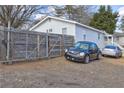 The backyard has a wooden fence, gravel parking area, and space for two cars at 840 Forrest St, Roswell, GA 30075