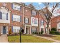 Row of townhouses with brick facade and autumn trees at 3348 Chastain Gardens Nw Dr, Kennesaw, GA 30144