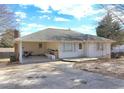 White Ranch style home with covered patio, driveway, and a large backyard at 830 Forrest St, Roswell, GA 30075