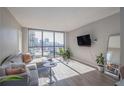 Modern living room with hardwood floors and city views at 1280 W Peachtree Nw St # 2207, Atlanta, GA 30309