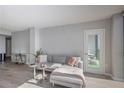 Spacious living room featuring a sectional sofa and access to a balcony at 1280 W Peachtree Nw St # 2207, Atlanta, GA 30309