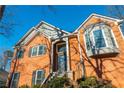 Brick home with a large front door and bay window at 1240 Cottonwood Trl, Cumming, GA 30041