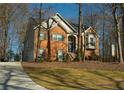 Two-story house with a driveway and mature trees surrounding at 1240 Cottonwood Trl, Cumming, GA 30041