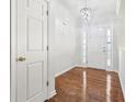 Bright foyer with hardwood floors and a modern chandelier at 245 London Ln, Hiram, GA 30141