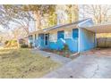 Front view of a blue house with a driveway and landscaping at 3024 Catalina Dr, Decatur, GA 30032