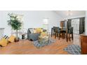 Living room with hardwood floors, comfortable seating, and a dining area at 3251 Hunters Crossing Pt, Lithonia, GA 30038