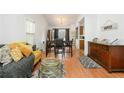 Living room with hardwood floors, comfortable seating, and a dining area at 3251 Hunters Crossing Pt, Lithonia, GA 30038