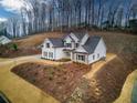 Stunning aerial view of a charming home on a wooded lot at 7760 Pleasant Hollow Ln, Cumming, GA 30041