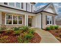 Inviting front entrance with brick columns and a walkway at 7760 Pleasant Hollow Ln, Cumming, GA 30041