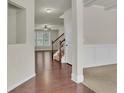 Two-story foyer with hardwood floors, staircase, and neutral color palette at 1354 Slate Bend Dr, Dacula, GA 30019