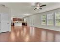 Spacious living area with hardwood floors, large windows, and access to kitchen at 1354 Slate Bend Dr, Dacula, GA 30019
