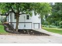 Side view of a white house with a walkway and landscaping at 754 Fayetteville Se Rd, Atlanta, GA 30316