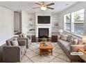 Virtually staged living room with fireplace, built-in shelving, and hardwood floors at 5823 Keystone Pt, Lithonia, GA 30058