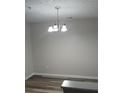 Bright dining room with chandelier and wood-look floors at 6101 Waldrop Pl, Decatur, GA 30034