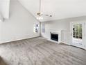 Spacious living room featuring vaulted ceilings, fireplace and neutral carpeting at 508 Kensington Park Dr, Canton, GA 30114