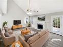 Virtually staged living room with vaulted ceilings, fireplace, and French doors at 508 Kensington Park Dr, Canton, GA 30114