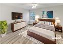 Virtually staged main bedroom with a king-size bed, dresser and nightstands at 508 Kensington Park Dr, Canton, GA 30114