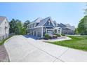 Large driveway with ample parking leading to a stylish home with well-kept front yard at 535 Crested Hawk Rdg, Canton, GA 30114