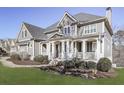 Gray two story house with wrap around porch and manicured lawn at 535 Crested Hawk Rdg, Canton, GA 30114