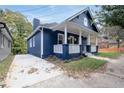 Newly renovated home with a blue exterior, white columns, and a large front yard at 774 Tift Sw Ave, Atlanta, GA 30310