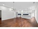 Spacious living room with hardwood floors and a modern light fixture at 774 Tift Sw Ave, Atlanta, GA 30310