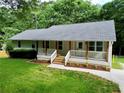 Inviting home featuring a cozy front porch, fresh landscaping, and a well-kept green lawn at 641 Virginia Ave, Suwanee, GA 30024