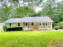 Charming single story home with a welcoming front porch and well maintained lawn and mature trees at 641 Virginia Ave, Suwanee, GA 30024