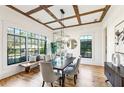 Bright dining room with wood floors, coffered ceilings, a wooden bench, and large windows at 812 Stratford Rd, Avondale Estates, GA 30002