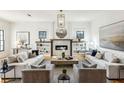 Elegant living room featuring neutral furniture, built-in bookshelves, and a cozy fireplace at 812 Stratford Rd, Avondale Estates, GA 30002