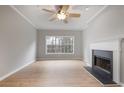 Living room with hardwood floors, fireplace, and large window at 907 Vinings Forest Se Ln, Smyrna, GA 30080