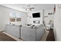 Bright living room featuring a fireplace, television, and comfortable gray sectional sofa at 79 Dew Drop Ln, Dallas, GA 30157