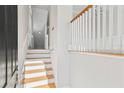 Interior view of a light-filled staircase with wooden steps and white railings at 1608 Mosaic Way, Smyrna, GA 30080
