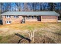 Ranch style brick home with a carport and mature trees at 4027 Lauada Dr, Douglasville, GA 30135