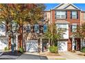 Brick front of townhome with trees and landscaping at 2159 Meadow Peak Rd, Duluth, GA 30097