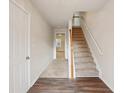 Bright foyer with a staircase and wood-look flooring, offering a welcoming entrance at 2159 Meadow Peak Rd, Duluth, GA 30097