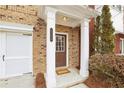 Close-up of the inviting front entrance with a classic brown door and white supporting pillars at 2159 Meadow Peak Rd, Duluth, GA 30097