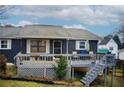 Gray house with a large deck and stairs leading to the yard at 2515 Impala Dr, Cumming, GA 30041