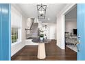Bright entryway with hardwood floors, a round table, and stairs at 7535 Cordery Rd, Cumming, GA 30040