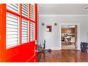 Red front door opens to hardwood floors and a view of the kitchen at 1091 Longley Nw Ave, Atlanta, GA 30318