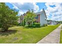 Two-story brick house with a side view and landscaped yard at 6684 Crane Ave, Fairburn, GA 30213