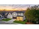 Two-story home with white brick and a landscaped yard at sunset at 9165 Golfview Ln, Covington, GA 30014