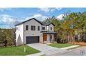 Two-story home with white brick, dark trim, and a wood front door at 9165 Golfview Ln, Covington, GA 30014