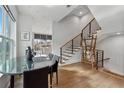 Elegant dining area with a glass table, modern staircase, and hardwood floors at 75 Boulevard Ne # 1, Atlanta, GA 30312