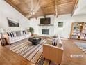 Bright living room features vaulted ceilings, hardwood floors, stone fireplace and modern furnishings at 2781 Interlaken Dr, Marietta, GA 30062