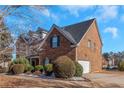 Brick home with a two-car garage and manicured landscaping at 1912 Wheat Valley Cir, Conyers, GA 30013